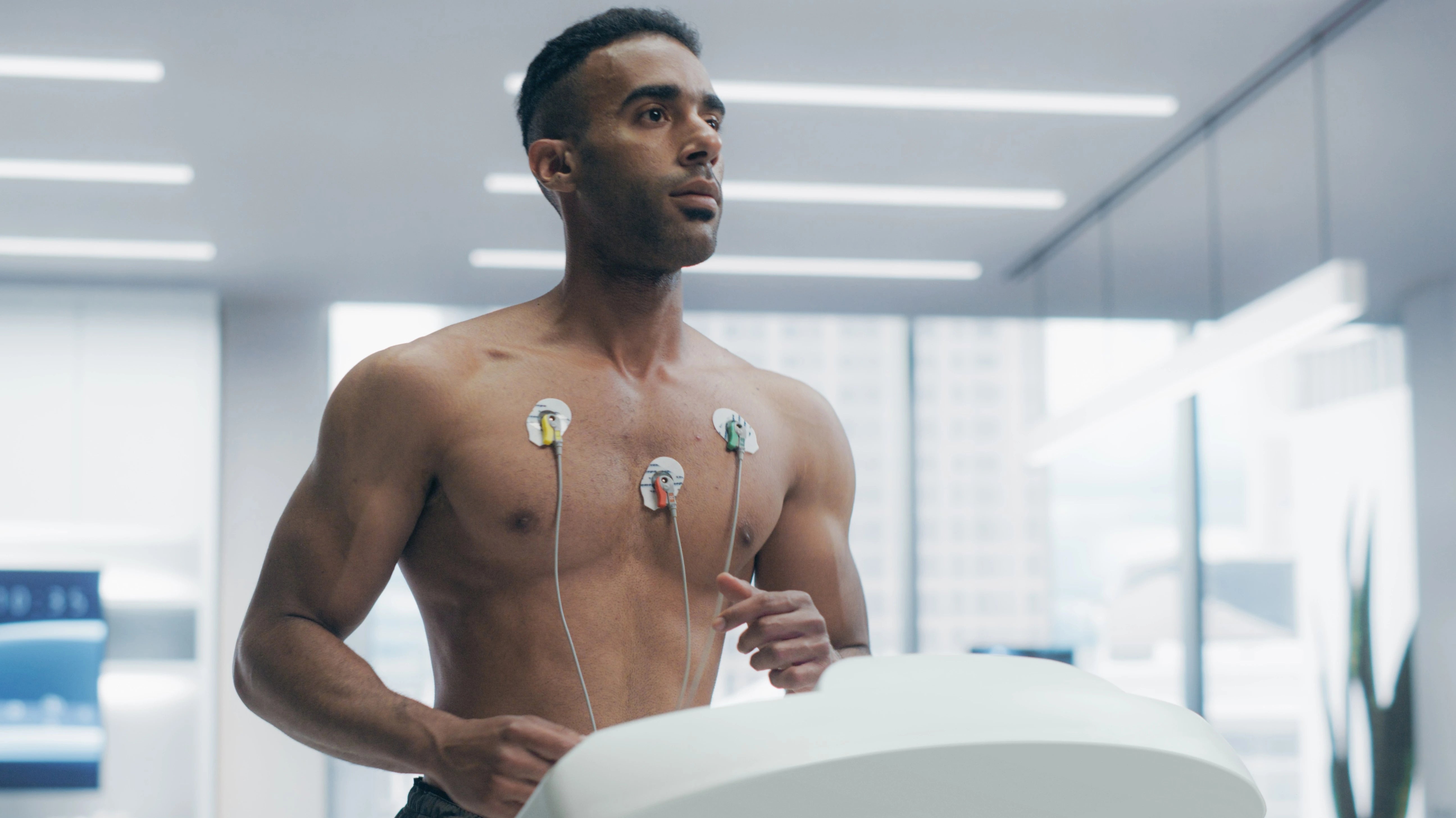 Man with electrodes on his chest in a medical setting